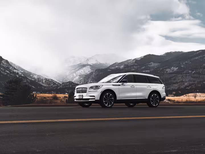 A white SUV on a mountain road