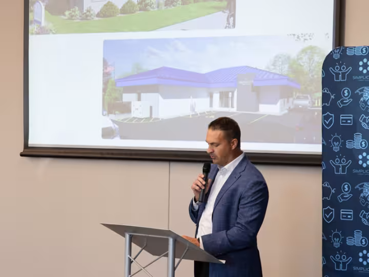 A Simplicity leader presenting at a podium